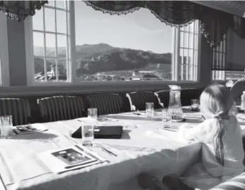  ??  ?? A young girl takes notes in an etiquette class at the Broadmoor in Colorado Springs.