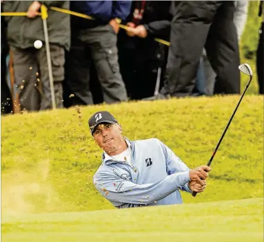  ?? ALASTAIR GRANT / AP ?? Matt Kuchar (blasting from a bunker on the 16th hole Friday) battled through Royal Birkdale’s wind to card three birdies and four bogeys for a 1-over 71. He will play in the final third-round group today with leader Jordan Spieth.