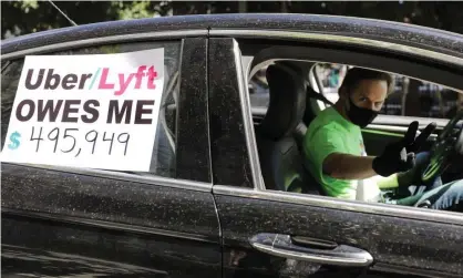  ?? Photograph: Mario Tama/Getty Images ?? A driver joins a protest calling for California to enforce the AB5 gig law against Uber and Lyft.