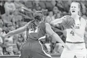  ?? Sue Ogrocki / Associated Press ?? Baylor point guard Kristy Wallace, right, set a Big 12 Tournament record with 15 assists in the win over Kansas State on Sunday at Oklahoma City.