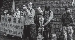  ?? ISAAC LAWRENCE/GETTY-AFP ?? An activist holds an effigy of President Donald Trump at a protest Saturday in Hong Kong.