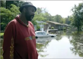  ?? ZACH FRAILEY — DAILY FREE PRESS VIA AP ?? William Murrell stands at the edge of his property, which is partially underwater, on Cedar Lane in Kinston, N.C. , Friday. Murrell and his wife Jo Ann weathered the storm following Hurricane Floyd in 1999 and chose to do this same during Hurricane Matthew.