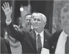  ?? CAROLYN KASTER, AP ?? Vice President- elect Mike Pence waves as he arrives Tuesday at Trump Tower in New York City.