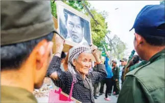  ?? HENG CHIVOAN ?? An elderly supporter of detained ‘filmmaker’ Rath Rott Mony is among protestors who gathered for a third time outside the Russian embassy demanding his release on Wednesday.