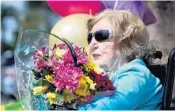  ?? SUSAN STOCKER/SOUTH FLORIDA SUN SENTINEL ?? Holocaust survivor Hilda Frenkel of Hallandale Beach watches well wishers from Goodman Jewish Family Services as they celebrate her 100th birthday.