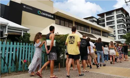  ?? Photograph: Chris Hyde/Getty Images ?? Covid lockdowns sparked queues outside Centrelink offices. More than 11,700 welfare recipients have now been told they owe money after receiving jobkeeper.