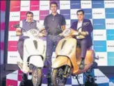  ?? RAMESH PATHANIA/MINT ?? (From left) Union minister Nitin Gadkari, Bajaj Auto MD Rajiv Bajaj and NITI Aayog CEO Amitabh Kant at the launch of electric scooter Chetak in New Delhi.