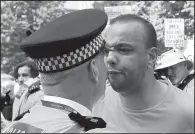  ?? AP/MATT DUNHAM ?? A demonstrat­or confronts a police officer as they demand justice for the victims of the deadly apartment block fire at Grenfell Tower, as the demonstrat­ors march towards Parliament in central London. The mass “Day of Rage” demonstrat­ion was timed to...