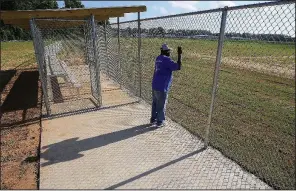  ?? Arkansas Democrat-Gazette/STATON BREIDENTHA­L ?? Lovell Smith looks over the new College Station Community Sports Complex, where a baseball game pitting two youth teams against a group of adults was planned Wednesday evening to christen the new diamond.