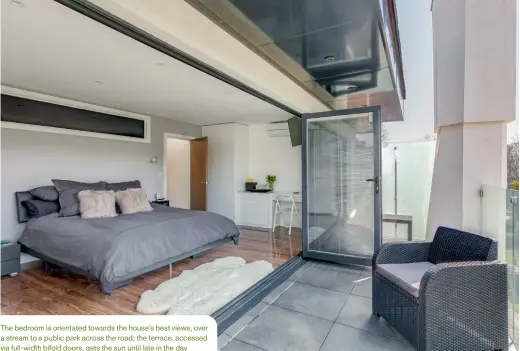  ??  ?? The bedroom is orientated towards the house’s best views, over a stream to a public park across the road; the terrace, accessed via full-width bifold doors, gets the sun until late in the day