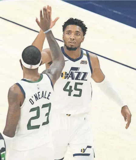  ?? RUSSELL ISABELLA/ USA TODAY SPORTS ?? Donovan Mitchell celebrates with Royce O’Neale during the win over the Celtics on Tuesday that helped the Jazz retain the best record ( 20- 5) in the NBA.