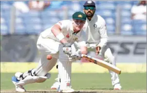  ??  ?? India’s Murali Vijay watches as Australia’s Matthew Renshaw plays a shot during the first day of the first Test in Pune yesterday.