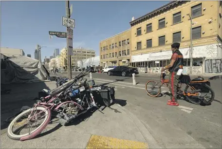  ?? Genaro Molina Los Angeles Times ?? CRITICS OF the new ordinance say it would target indigent people who earn money repairing and assembling bicycles on the streets.