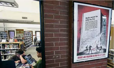  ?? — AP ?? War of ideas: A copy of the 1942 ‘Books cannot be killed by fire’ Office of War Informatio­n poster hanging in a hallway of the Rochester Public Library, New Hampshire.