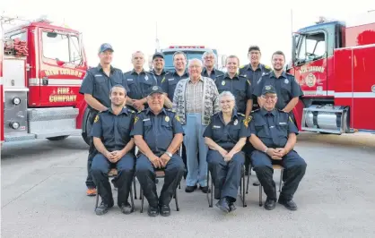  ?? MILLICENT MCKAY/JOURNAL PIONEER ?? Arthur Johnston, centre, is shown with the members of the New London Fire Company following a recent gathering where he saw the two new-to-them trucks that his donation to the company paid for.