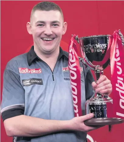  ?? Lawrence Lustig/PDC ?? ●●Nathan Aspinall with the UK Open trophy