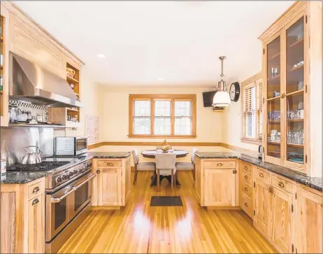  ?? Real Living Wareck D’Ostilio Real Estate ?? The eat-in kitchen at 94 East Rock Road in New Haven features stainless steel appliances and custom-built cabinets.