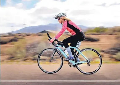  ?? JIIM THOMPSON/JOURNAL ?? Carol Akright pedals along Loma Larga Road in Corrales on a recent training run. She plans to compete in her 97th triathlon Saturday at White Sands Missile Range and intends to reach 100 swim-bike-run events later this year.