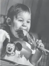  ?? ?? A child enjoys a turkey leg on Thanksgivi­ng in years past.