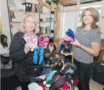  ?? KIM STALLKNECH­T/PNG ?? Barbara Verner, left, and Nicole Curtis-Gill of Bonaccord elementary in Guildford applied to Adopt-A-School for money to buy clothes, shoes and food for students. Need has outstrippe­d the school’s ability to fundraise.