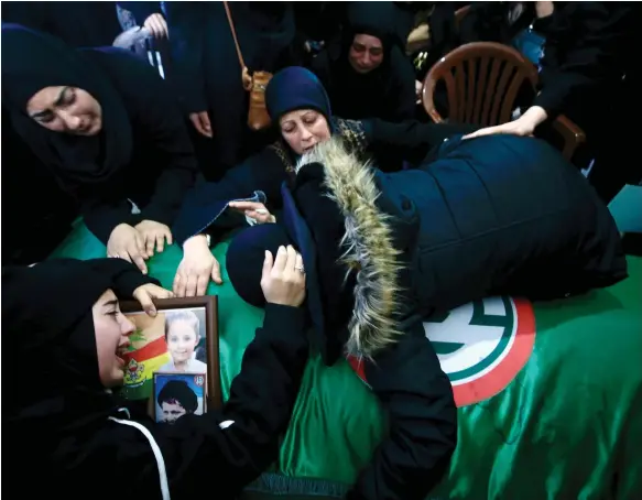  ?? EPA ?? Clockwise from top, Fardous Saeed, the mother of Amal Al Dorr, lies on her coffin during her funeral in the village of Majdal Zoun, in southern Lebanon; a mourner carries a picture of Amal, five, during her funeral procession; a man weeps during the funeral