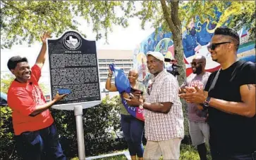  ?? Jennifer Reynolds Galveston County Daily News ?? SAM COLLINS III, left, and others celebrate at the Juneteenth historical marker in Galveston, Texas. Vice President Kamala Harris said: “We have come far and we have far to go, but today is a day of celebratio­n.”