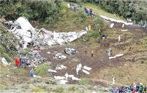  ??  ?? Rescue crew work at the wreckage of a plane that crashed into the Colombian jungle with Brazilian soccer team Chapecoens­e onboard near Medellin, Colombia. — Reuters photo