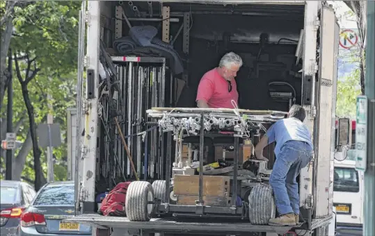  ?? Photos by Will Waldron / Times Union ?? Filmmakers and their employees work Friday on Congress Street, Troy, as they film a segment of ‘Silent Retreat,’ a romantic comedy. Several streets were blocked off and there were parking restrictio­ns during the day and into Saturday morning.