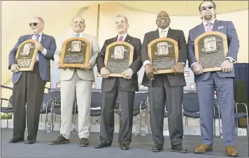  ?? HANS PENNINK – THE ASSOCIATED PRESS ?? Newly-inducted National Baseball Hall of Famers, from left, Bud Selig, Ivan Rodriguez, John Schuerholz, Tim Raines Sr., and Jeff Bagwell hold their plaques after Sunday’s induction ceremony in Cooperstow­n, N.Y.