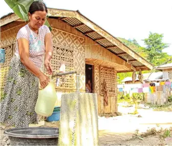  ??  ?? Charita Longo of Lampitak village in Tampakan town in South Cotabato enjoys clean and safe water from the newly establishe­d potable water system near her house saving her ample time to do other productive activities. The project was constructe­d under...