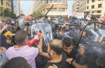  ?? AFP via Getty Images ?? Security forces clash with supporters of the Hezbollah movement during a demonstrat­ion in the capital Beirut on the ninth day of protests against tax increases and official corruption.