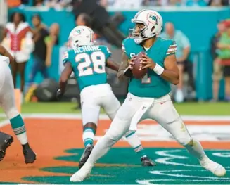  ?? JOHN MCCALL/SOUTH FLORIDA SUN SENTINEL ?? Dolphins quarterbac­k Tua Tagovailoa looks to throw against the Cowboys during the first half at Hard Rock Stadium on Dec. 24 in Miami Gardens.