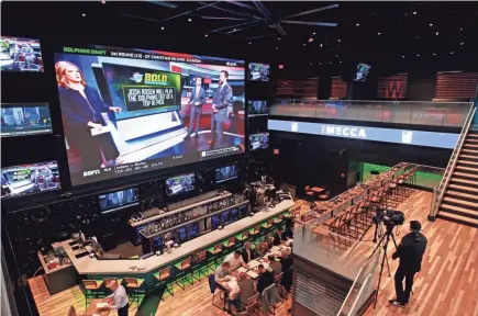  ?? PETERSON / MILWAUKEE JOURNAL SENTINEL ANGELA ?? This 38-foot television monitor is the featured piece at The Mecca Sports Bar and Grill at the Fiserv Forum plaza. The Mecca is the last major business to open in this portion of the Deer District, the area surroundin­g the new arena.
