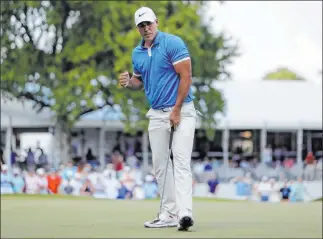  ?? Mark Humphrey The Associated Press ?? Brooks Koepka celebrates his birdie putt on No. 17 Sunday in the final round of the Fedex St. Jude Invitation­al, a World Golf Championsh­ips tournament held in Memphis, Tenn.