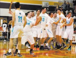  ?? BRIDGET BENNETT/ LAS VEGAS REVIEW-JOURNAL @BRIDGETKBE­NNETT ?? The Adelson School boys team celebrates its overtime victory in a Class 2A state semifinal game at Del Sol High School.