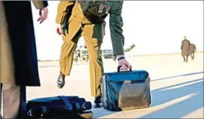  ?? DOUG MILLS/THE NEW YORK TIMES ?? The ‘nuclear football’, the satchel that always travels with the US president for use in a nuclear attack, on a runway at Joint Base Andrews as President Donald Trump boards Marine One, on January 18.