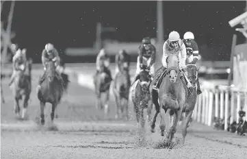  ?? — Reuters photo ?? Mike Smith rides Arrogate to the finish line to win the ninth and final race.