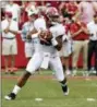  ?? MICHAEL WOODS — THE ASSOCIATED PRESS FILE ?? In this file photo, Alabama quarterbac­k Tua Tagovailoa rolls out before throwing a touchdown pass on the first play of the game against Arkansas in the first half of an NCAA college football game, in Fayettevil­le, Ark.