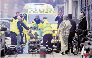  ?? Picture: GETTY ?? TERROR: A police officer is carried on to an ambulance following the Danish attacks