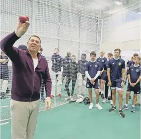  ?? ?? Shane Warne passes on his spinning expertise to younf would-be pros at Sussex’s Aldridge Academy last autumn