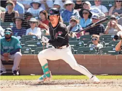  ?? ROB SCHUMACHER/THE REPUBLIC ?? Diamondbac­ks’ Corbin Carroll hits an RBI-single against the Mariners in Friday’s spring training game at Salt River Fields.