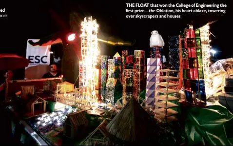  ??  ?? THE FLOAT that won the College of Engineerin­g the first prize—the Oblation, his heart ablaze, towering over skyscraper­s and houses