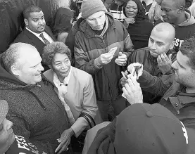  ?? J.P. Moczulski for National
Post ?? Former mayor Rob Ford, at left, is surrounded by fans taking
pictures as he arrives Friday at Ford Fest in Rexdale.