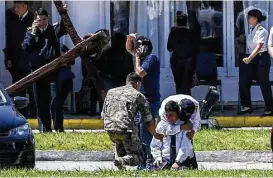  ?? Itan Abramovich photos / AFP / Getty Images ?? Relatives and comrades of 44 crew members of a missing Argentine submarine express their grief at Mar del Plata. A noise heard in the ocean near the last known position of the ARA San Juan was “consistent with an explosion,” officials said.