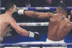  ?? Picture: AFP ?? COP THAT: Anthony Joshua (right) connects with a straight left against Joseph Parker during their heavyweigh­t bout.