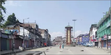  ?? AP PHOTO/SHEIKH SAALIQ ?? Kashmiri women walk at a deserted Lal Chowk square, a frequent site for anti-India protests, in Srinagar, Indian controlled Kashmir, on Thursday.