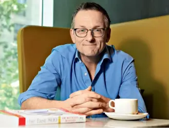  ??  ?? Creator of 5:2 diet Dr Michael Mosley with his new book The Fast 800. Picture: JOSIE HAYDEN