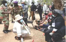  ??  ?? Minister of State for Bulawayo Provincial Affairs and Devolution Cde Judith Ncube pays her respects to the widow of the late Brigadier-General Sambulo Ndlovu, Sarah after burial at Lady Stanley Cemetery in Bulawayo yesterday