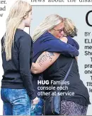  ??  ?? HUG Families console each other at service