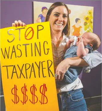  ?? WAYNE CUDDINGTON ?? Midwife Christi Baker, holding one-month-old Meara Godin, says a lack of pay equity for midwives is pushing some of them out of the practice.